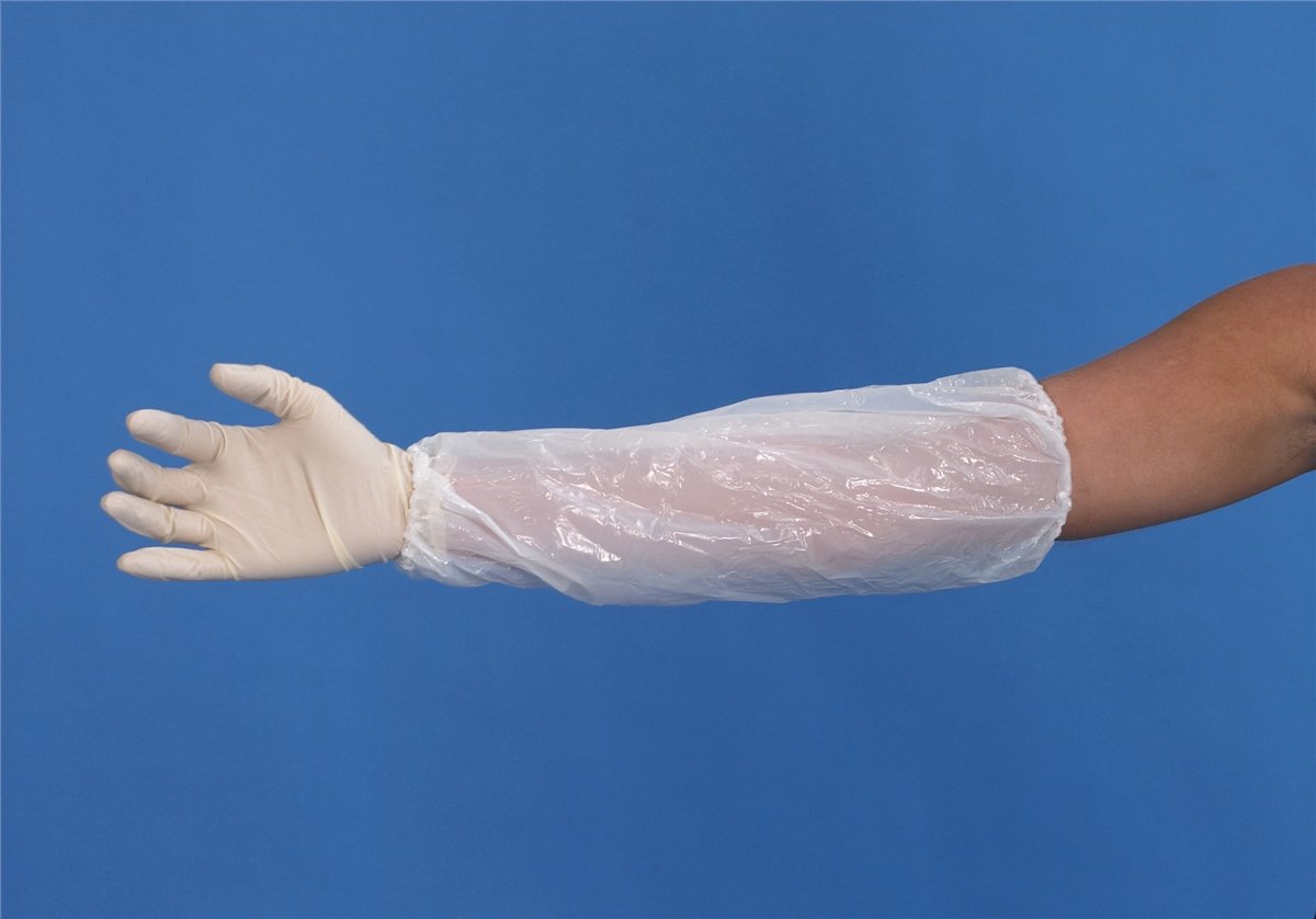 A white plastic protective sleeve worn over a person's arm and hand, with a white nitrile glove on the wrist, set against a solid blue background.