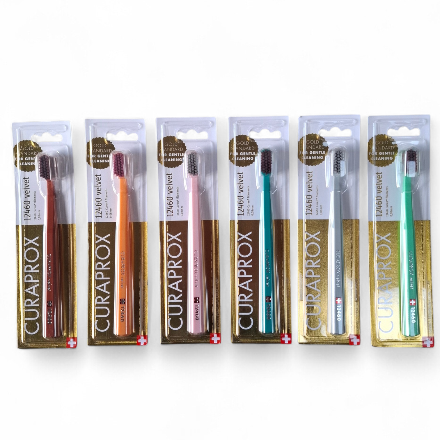 Set of Curaprox toothbrushes in their packaging on a white background