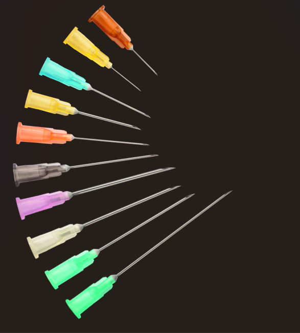 Needles of various colours and sizes on a black background