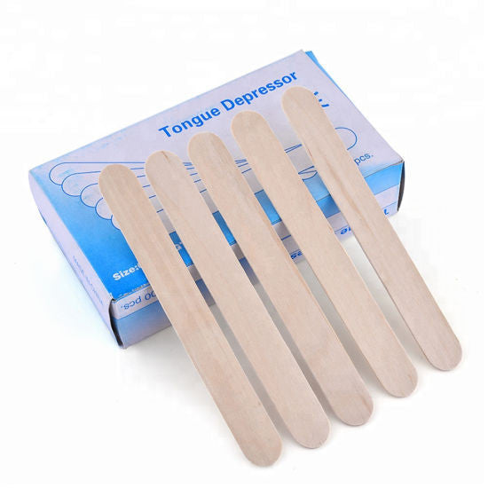 Set of tongue depressors with a packaging box on a white background